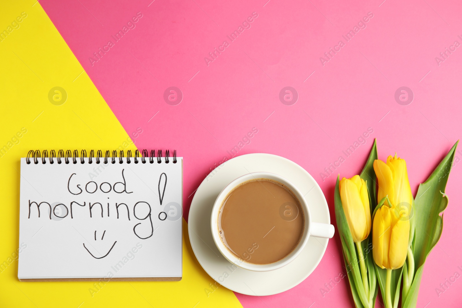 Photo of Delicious coffee, beautiful flowers and GOOD MORNING wish on color background, flat lay. Space for text