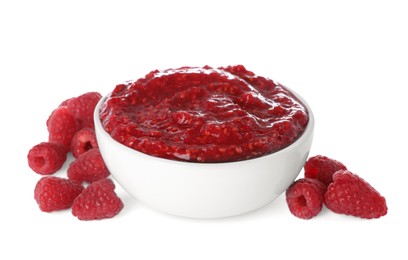 Photo of Raspberry puree in bowl and fresh berries on white background