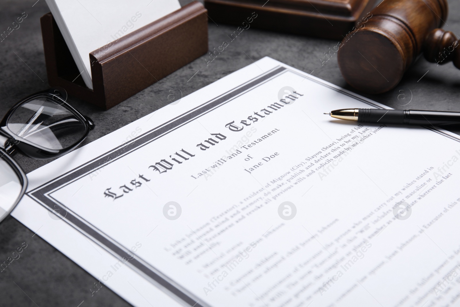 Photo of Last will and testament with pen on grey table, closeup