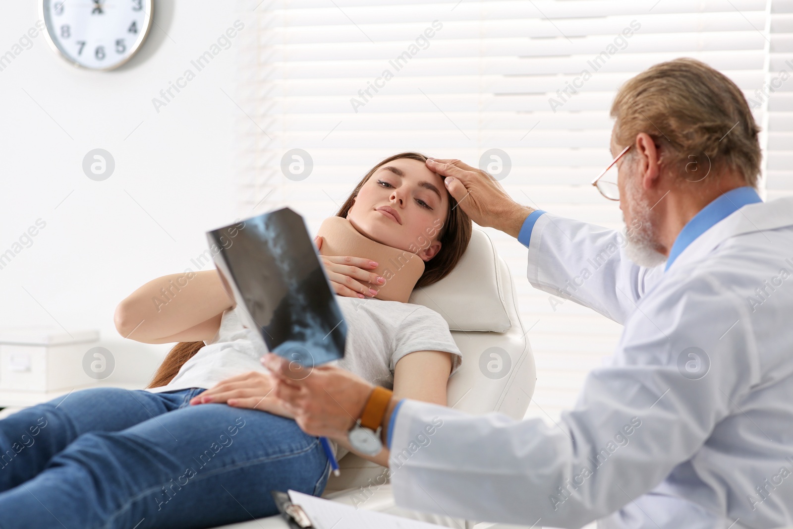 Photo of Orthopedist showing X-ray picture to patient in clinic