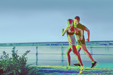 Image of People running outdoors, view through thermal camera. Temperature detection - Covid spreading prevention measure 