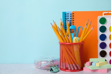 Photo of Different school stationery on table against light blue background, space for text. Back to school