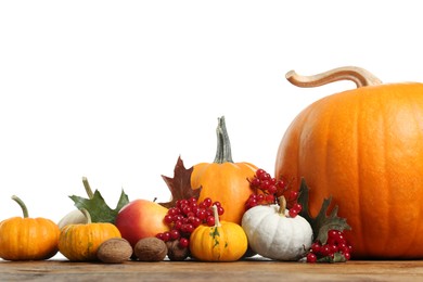 Photo of Happy Thanksgiving day. Composition with pumpkins, berries and walnuts on wooden table against white background. Space for text