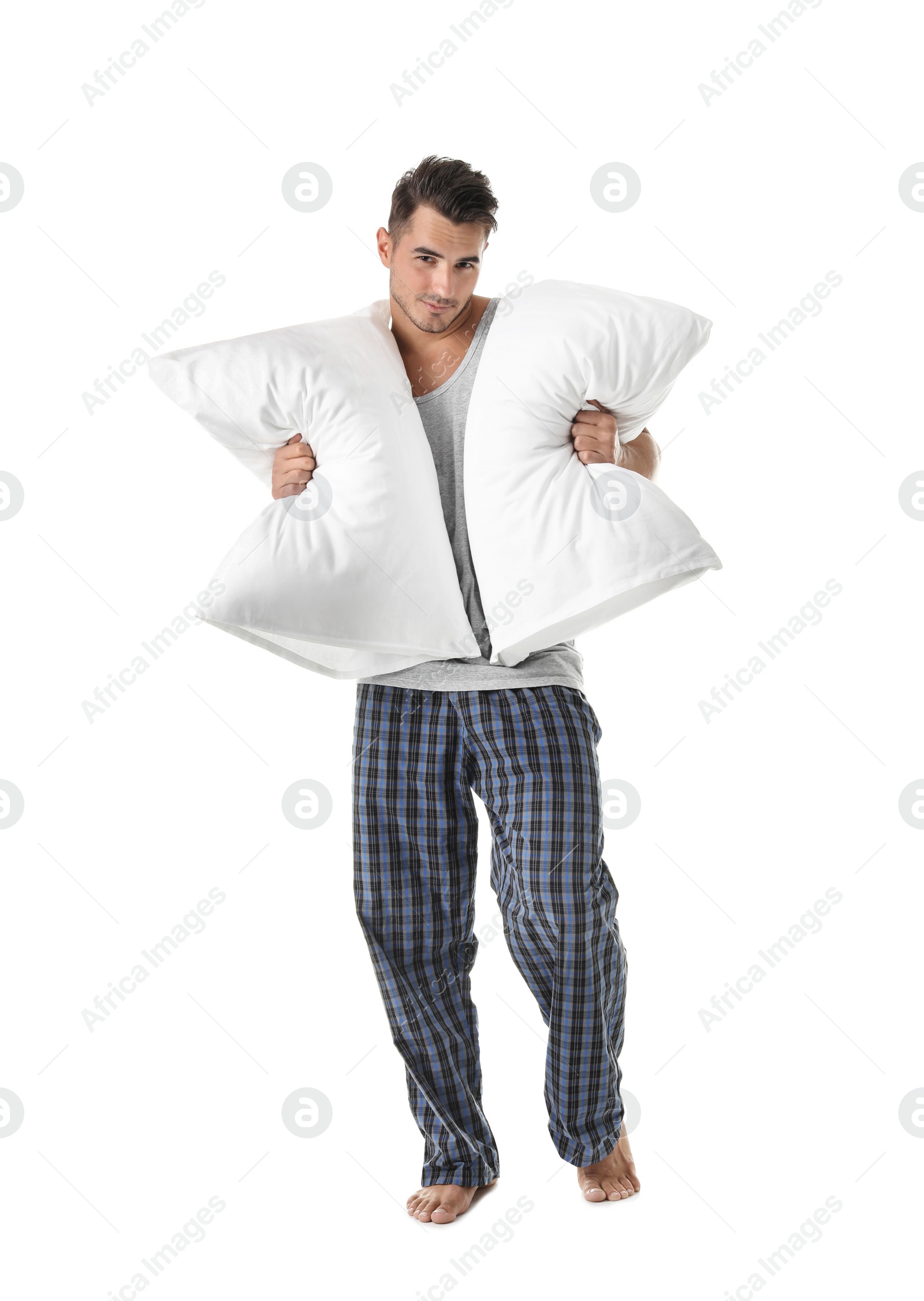 Photo of Young man with soft pillows on white background