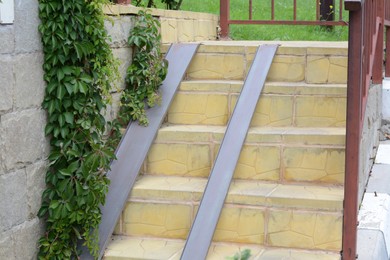 View of stone stairs with ramp outdoors
