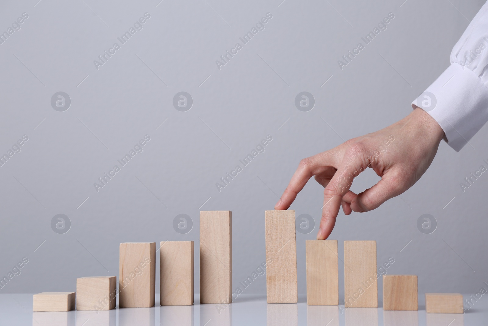 Photo of Woman trying to cross unfinished bridge with her fingers, closeup. Connection and risks concept