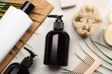 Photo of Flat lay composition with solid shampoo bars and bottles of cosmetic product on light grey table