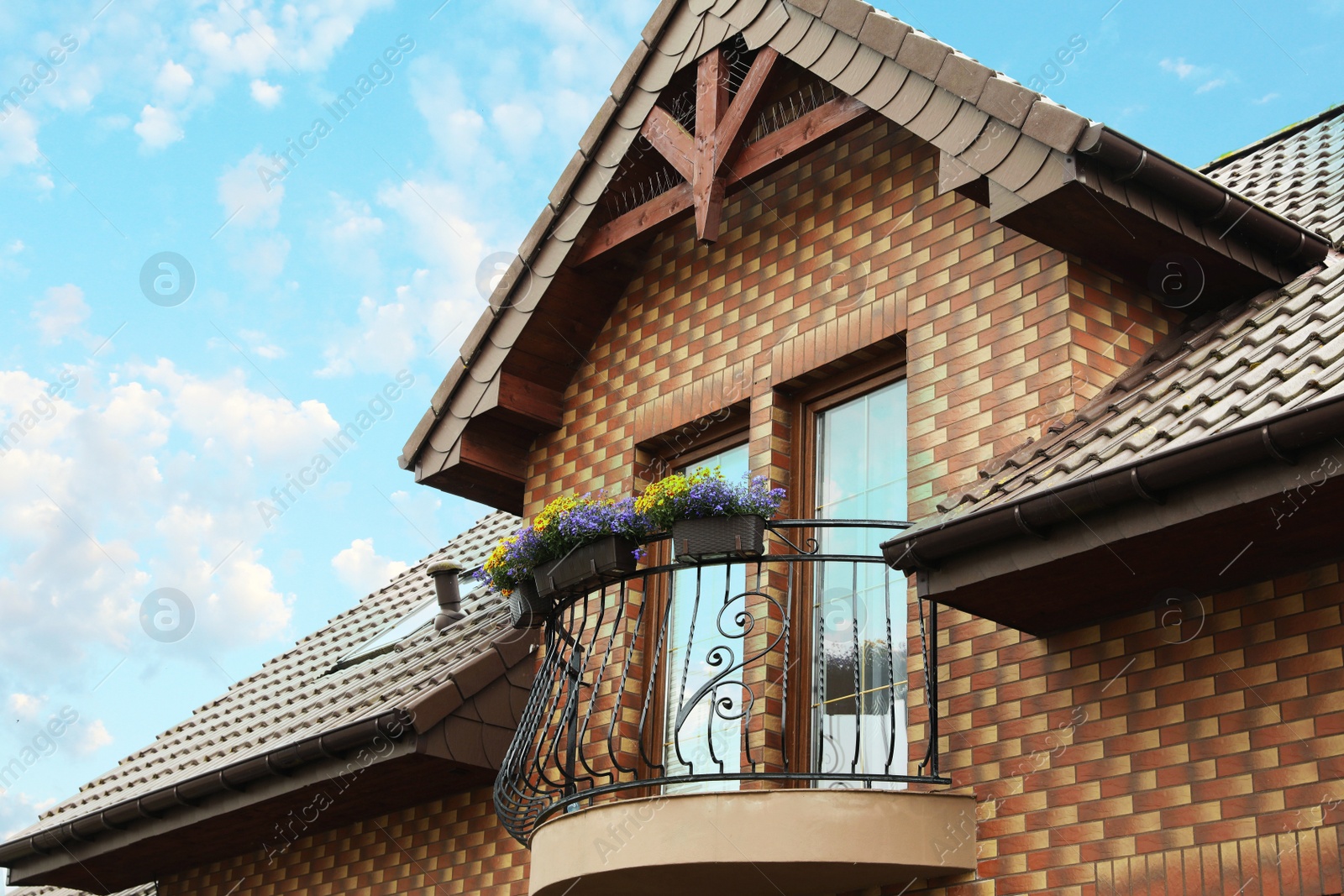 Photo of Stylish balcony decorated with beautiful potted flowers