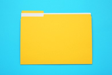 Yellow file with documents on turquoise background, top view 