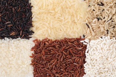 Photo of Different sorts of rice as background, top view