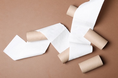 Photo of Flat lay composition with toilet paper and empty rolls on color background
