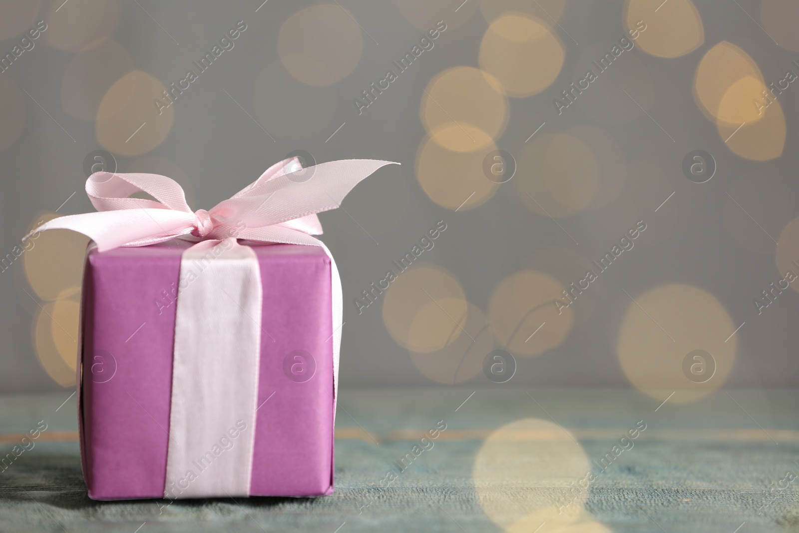 Photo of Gift box on wooden table, space for text. Valentine's Day celebration