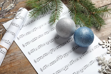 Photo of Composition with Christmas decorations and music sheets on wooden background