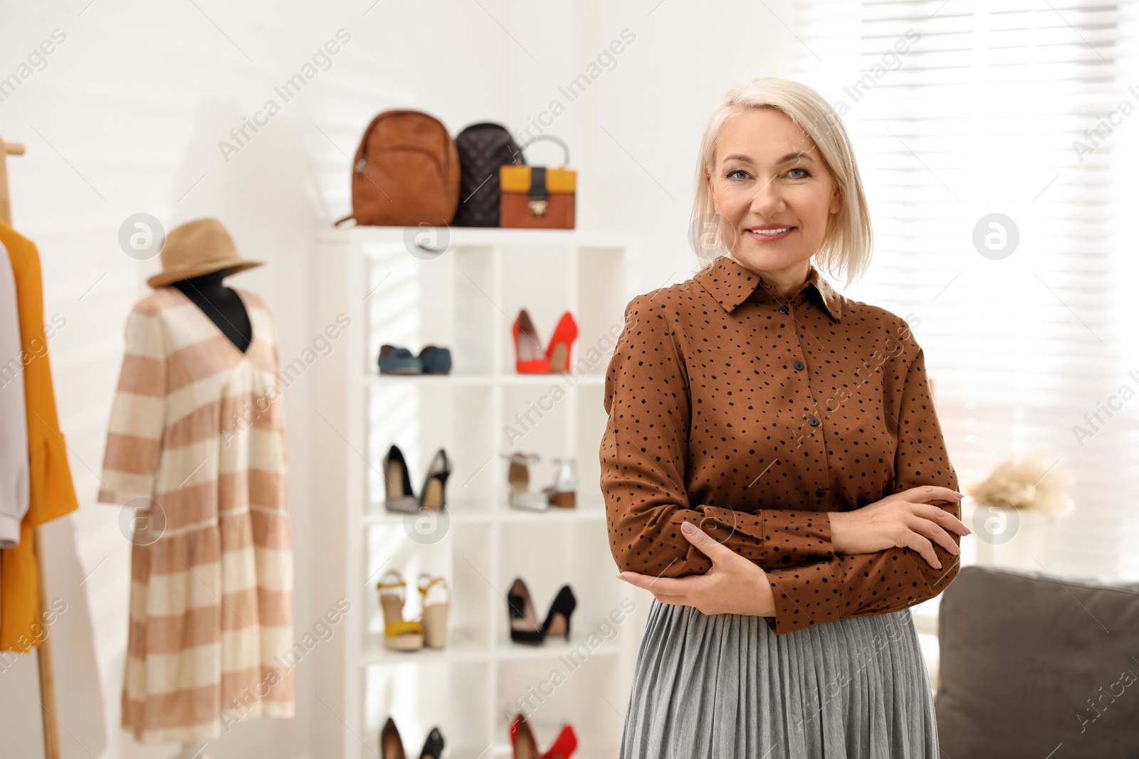 Photo of Female business owner in boutique. Space for text