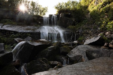 Photo of Picturesque view of mountain waterfall and green plants