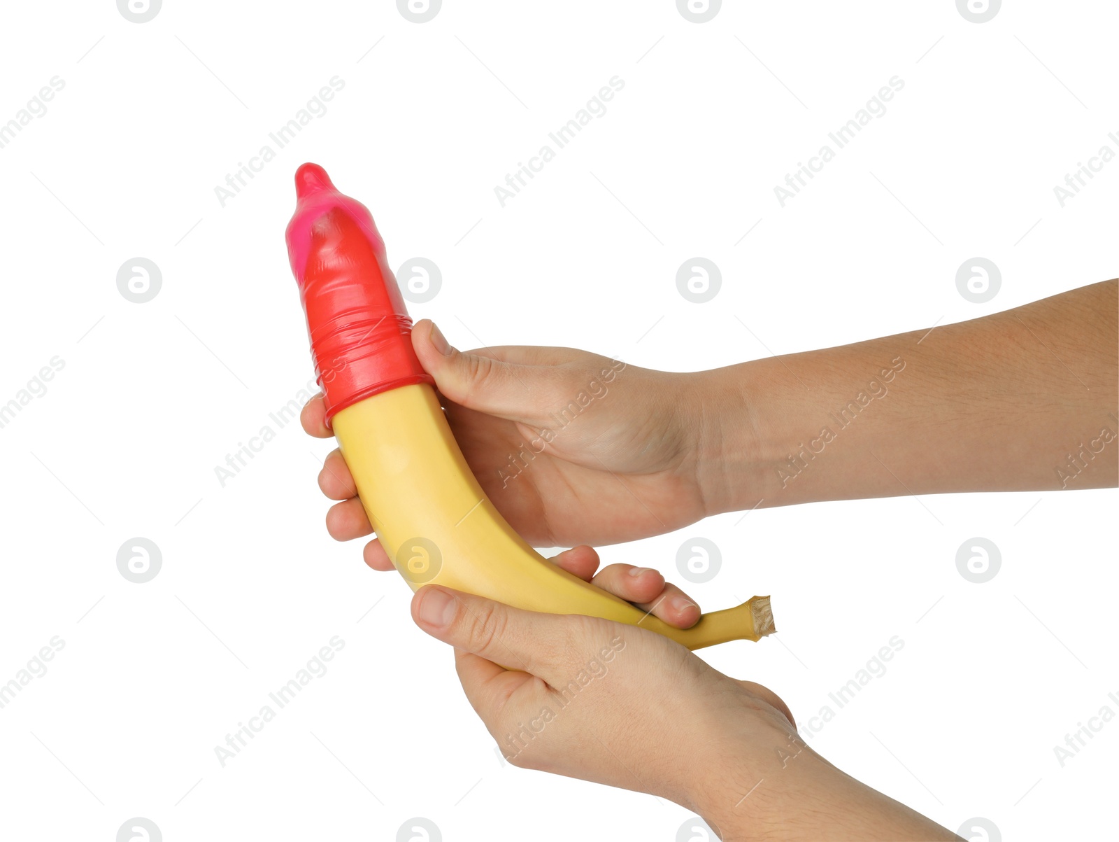 Photo of Woman holding banana in condom on white background, closeup. Safe sex concept