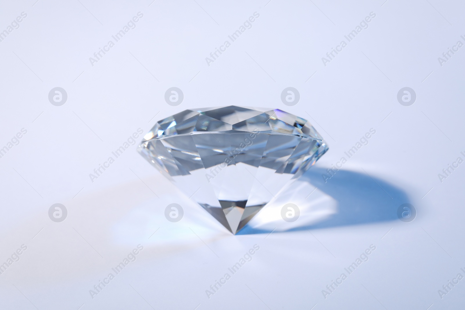 Photo of Beautiful dazzling diamond on white background, closeup