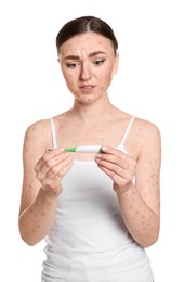 Woman with rash holding thermometer on white background. Monkeypox virus