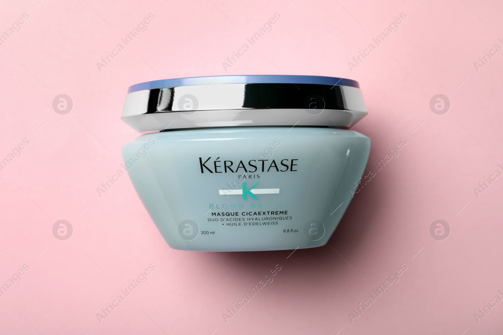 Photo of MYKOLAIV, UKRAINE - SEPTEMBER 07, 2021: Kerastase hair care mask on pink background, top view