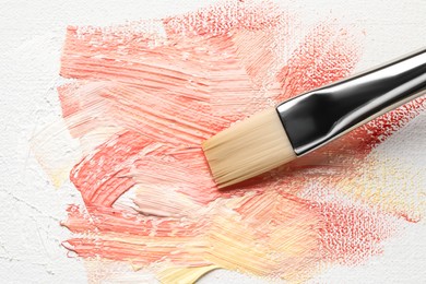 Photo of Painting beautiful strokes of colorful oil paints on canvas, closeup