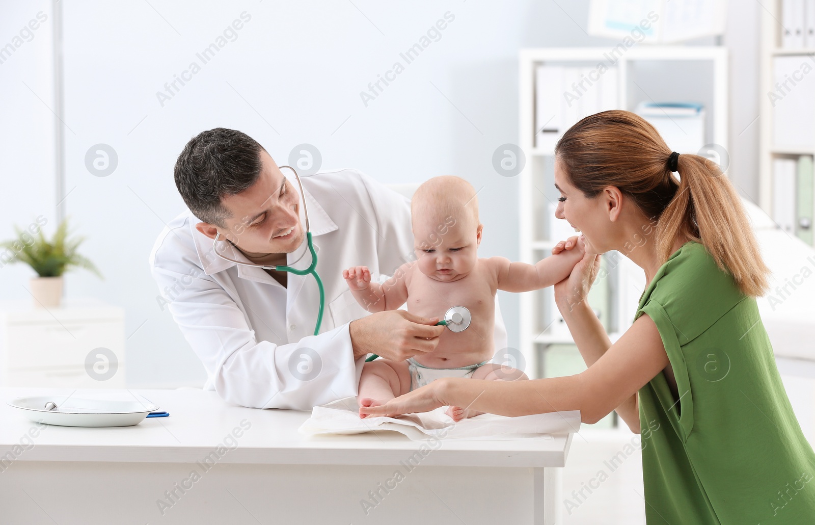 Photo of Woman with her baby visiting children's doctor in hospital