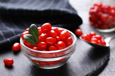 Bowl with fresh goji berries on slate plate, closeup