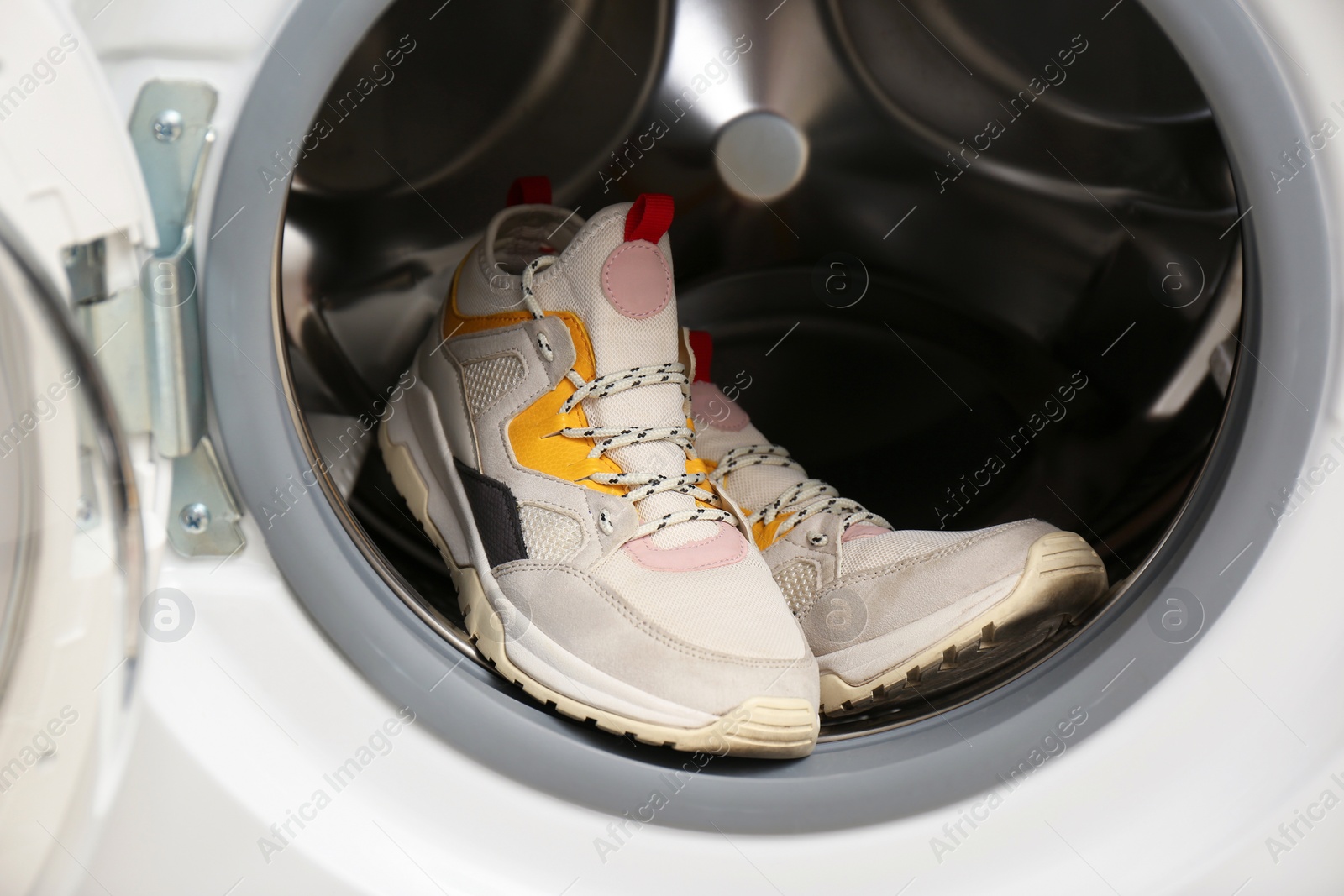 Photo of Clean sports shoes in washing machine drum