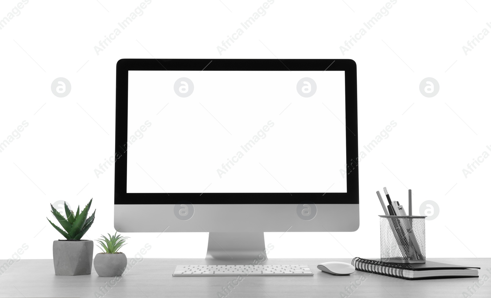 Photo of Computer, potted plants and stationery on table against white background. Stylish workplace