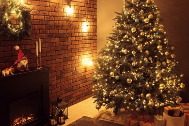 Beautiful tree with festive lights and Christmas decor in living room. Interior design