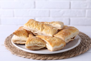 Photo of Delicious puff pastry on white wooden table