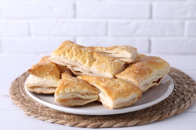 Delicious puff pastry on white wooden table