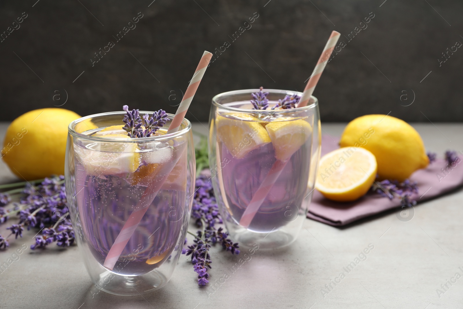 Photo of Fresh delicious lemonade with lavender on grey table