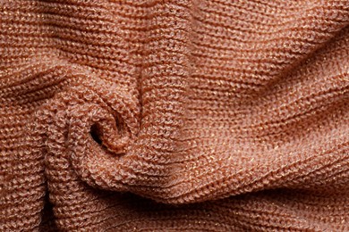 Brown knitted fabric as background, top view