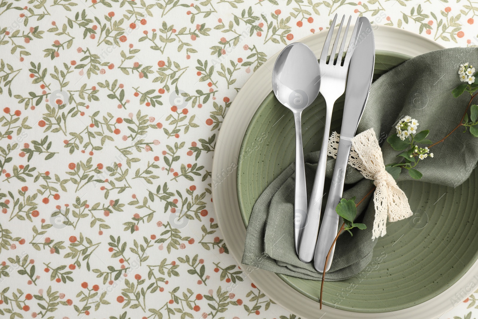 Photo of Stylish setting with cutlery, plates, napkin and floral decor on table, top view. Space for text