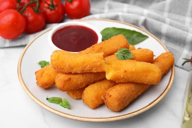 Tasty fried mozzarella sticks served with tomato sauce on white marble table