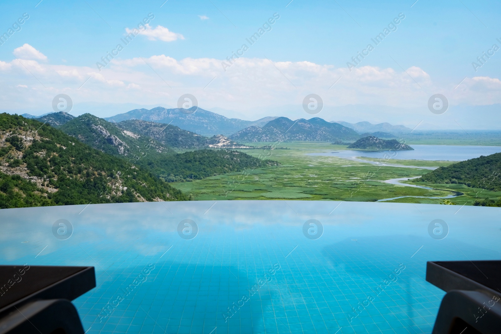 Image of Outdoor swimming pool at luxury resort and beautiful view of mountains on sunny day