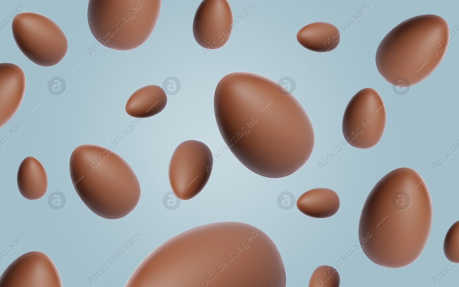 Image of Many chocolate eggs falling on dusty light blue background