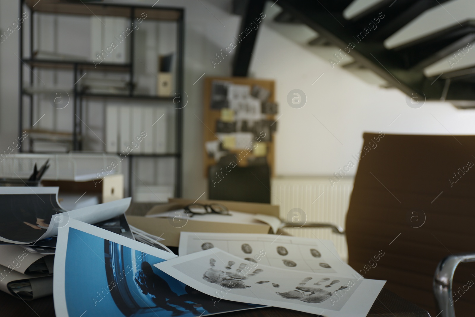 Photo of Crime scene photos and fingerprints on table, closeup. Detective agency