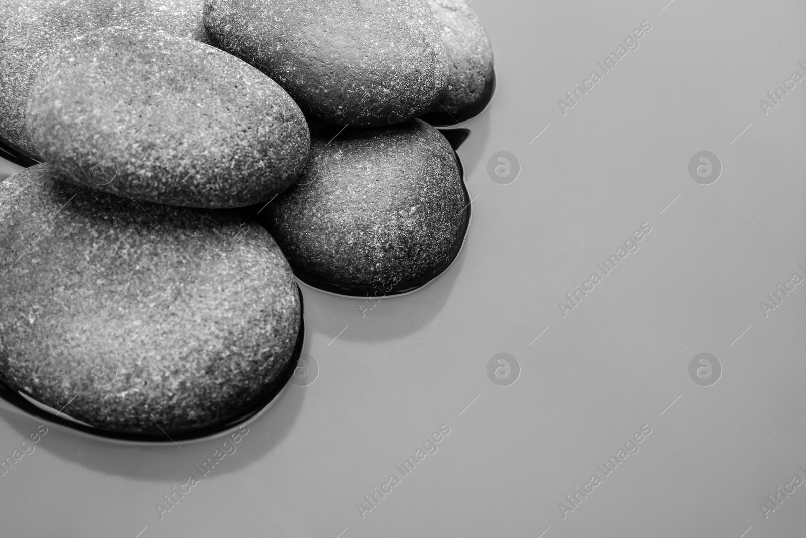 Photo of Stones in water, space for text. Zen lifestyle