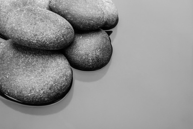 Photo of Stones in water, space for text. Zen lifestyle