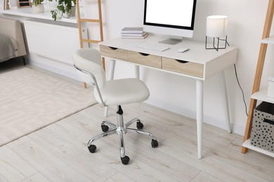 Photo of Workplace with comfortable office chair indoors. Interior design