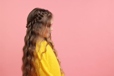 Cute little girl with braided hair on pink background. Space for text