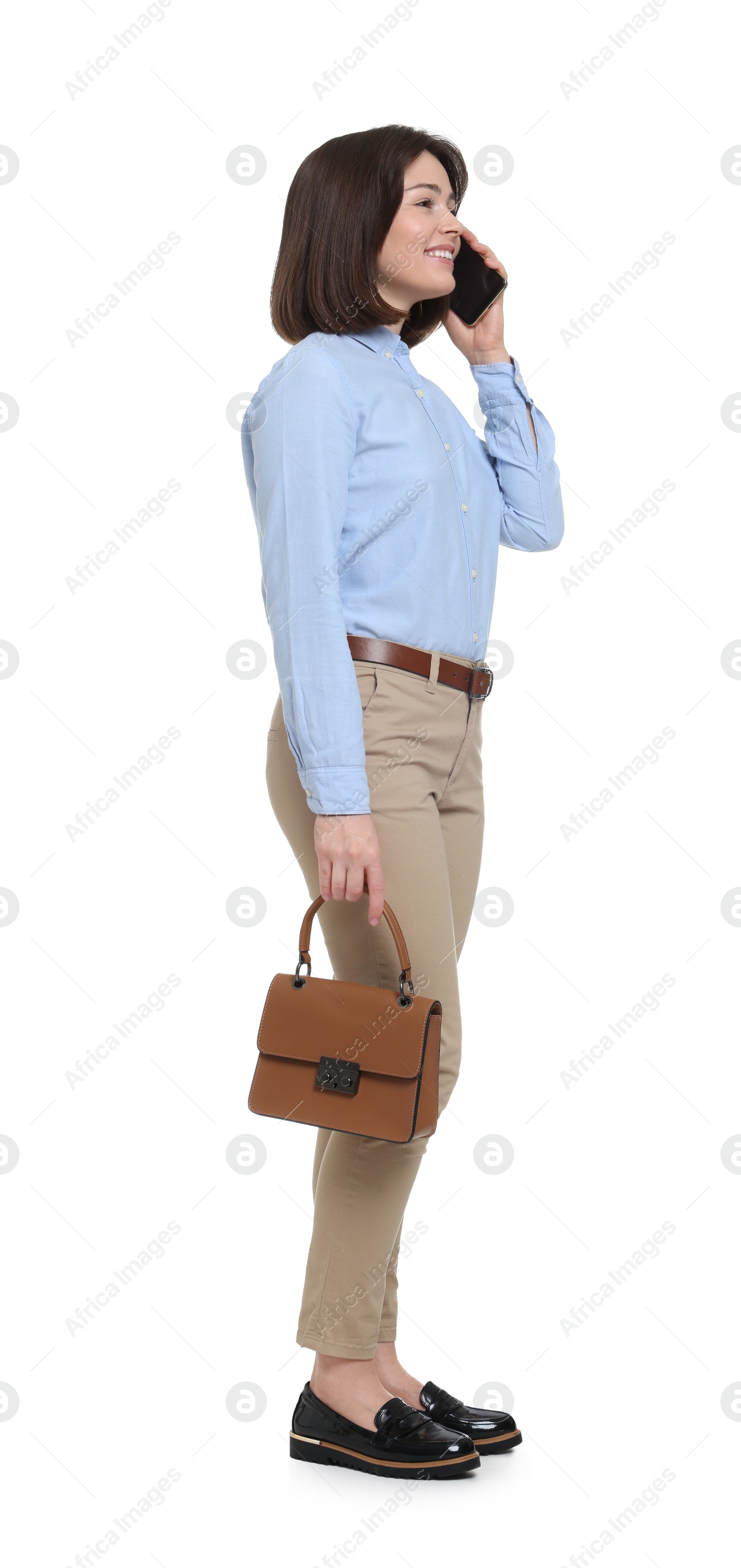 Photo of Happy woman with bag talking on smartphone against white background