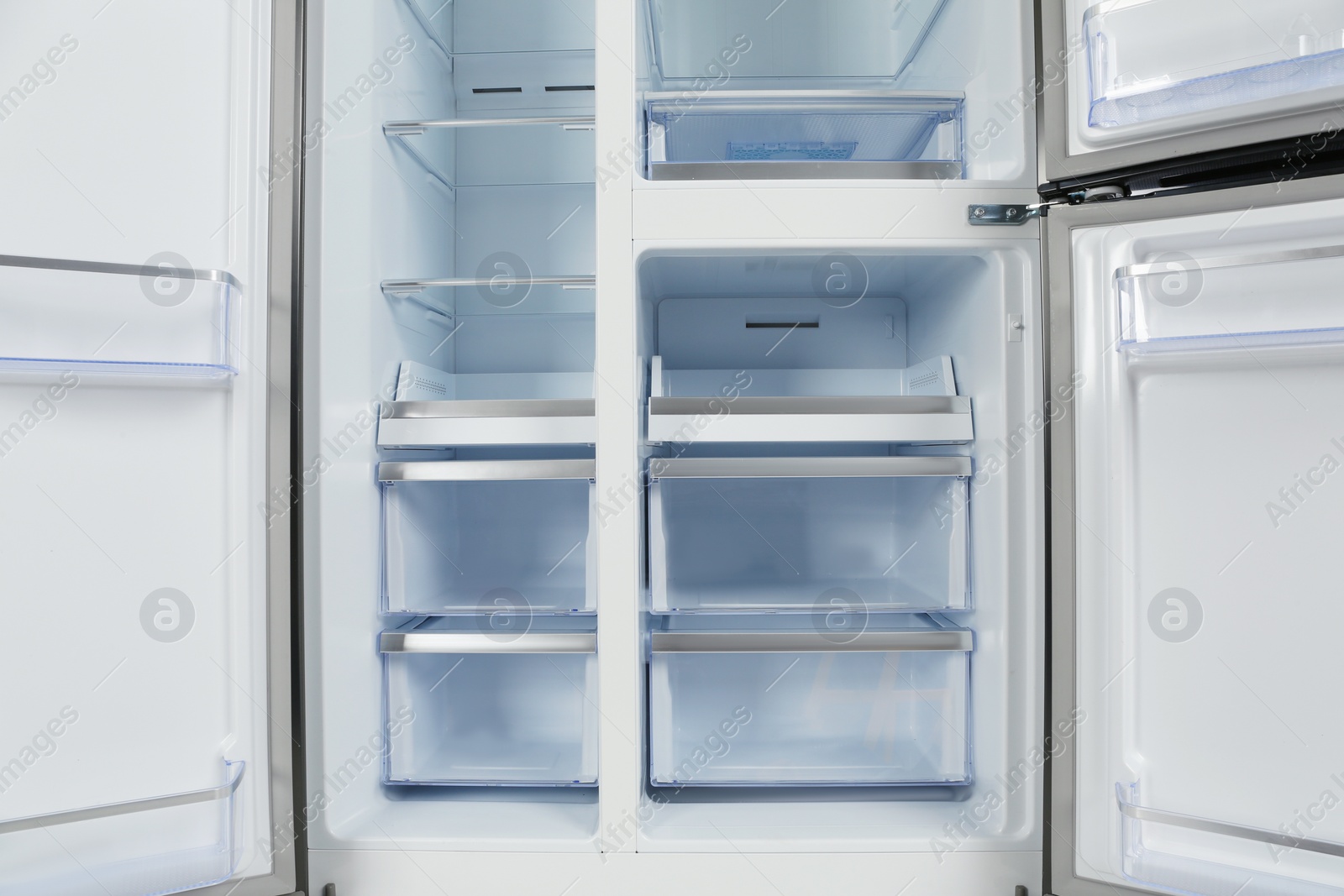 Photo of Shelves of empty modern refrigerator, closeup view