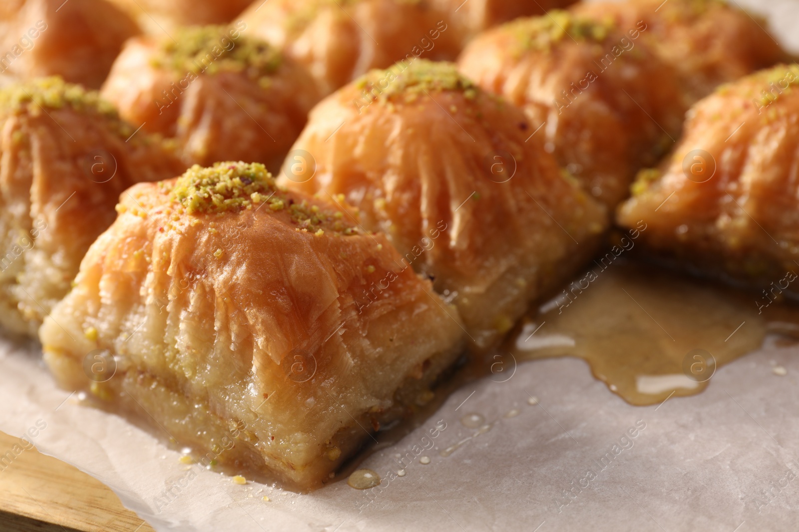 Photo of Delicious sweet baklava with pistachios on table, closeup