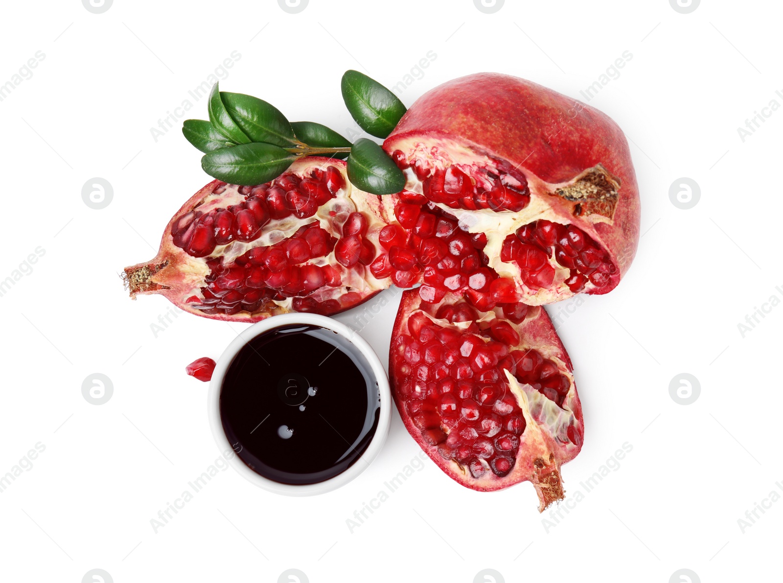 Photo of Tasty pomegranate sauce in bowl, branch and fruits isolated on white, top view