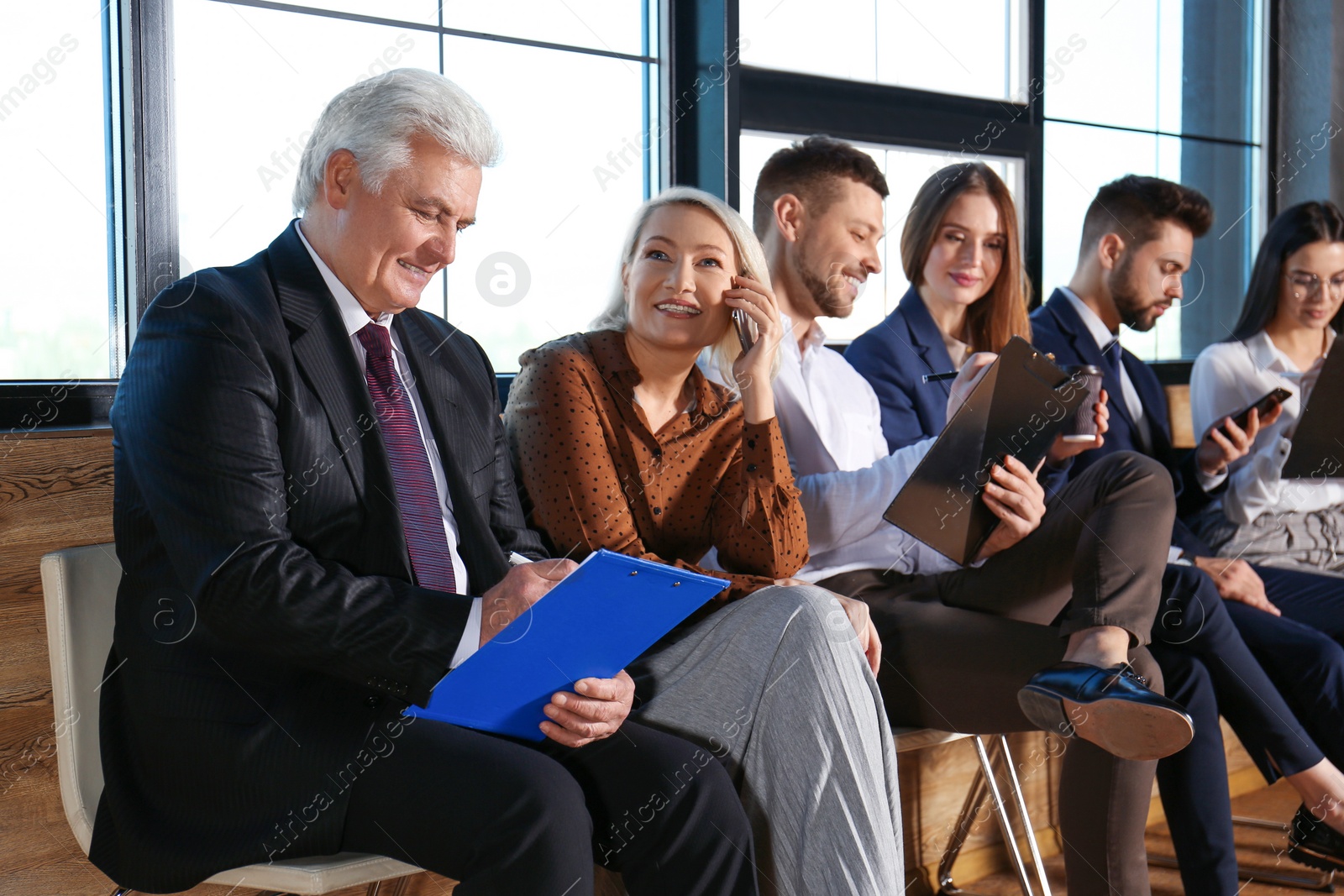 Photo of People waiting for job interview in office hall