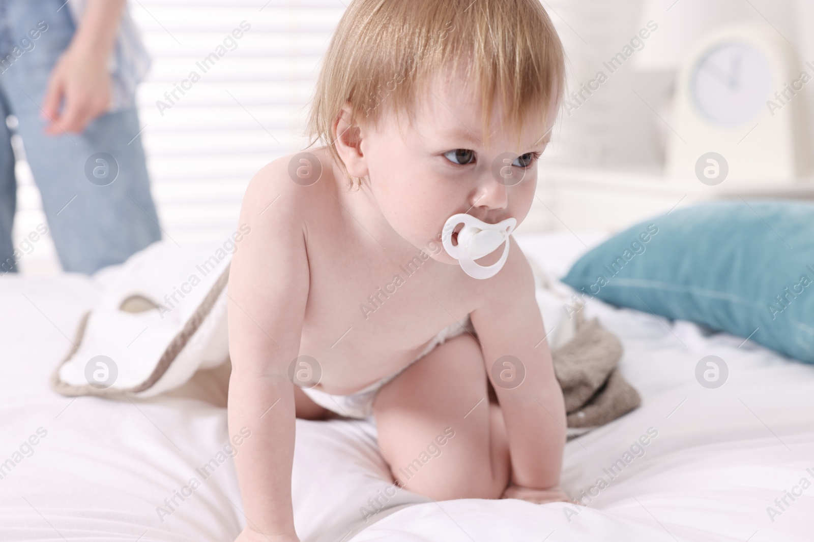 Photo of Cute little baby with towel after bathing on bed