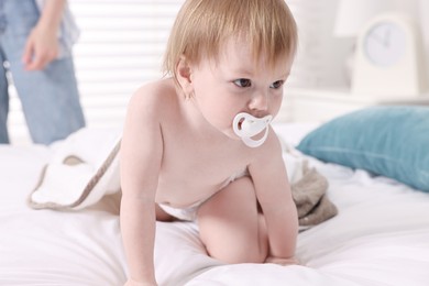 Photo of Cute little baby with towel after bathing on bed