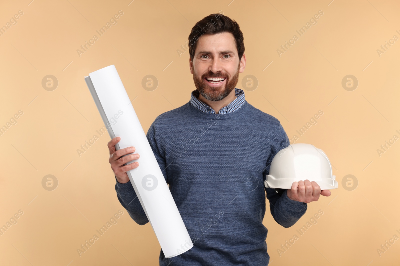 Photo of Architect with hard hat and draft on beige background